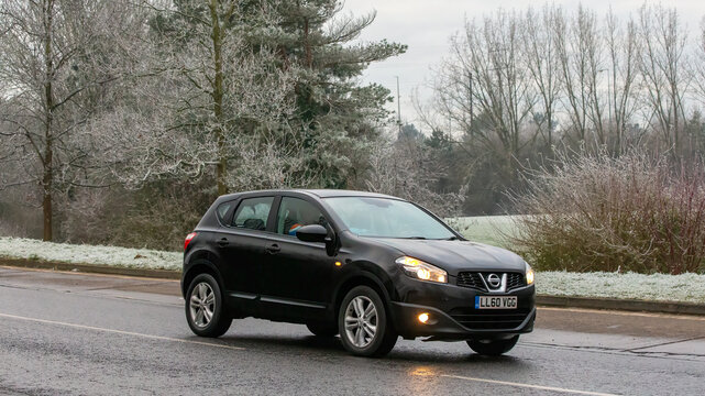 Milton Keynes,UK - Jan 12th 2025: 2010 Nissan Qashqai car driving on a cold,frosty morning