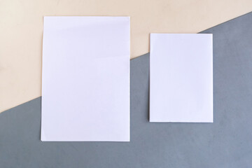 Two white mockup blanks on geometric grey and white background, copy space for the text