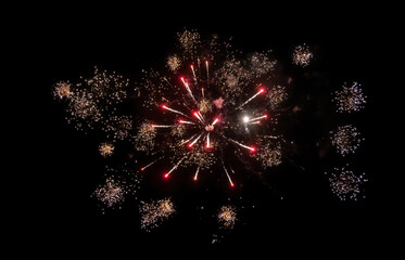 small red and yellow firework splahes in dark sky