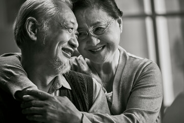 black and white portrait of loving senior asian couple happy and smiling