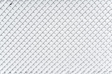 Naklejka premium A wire fence covered with snow in a blizzard