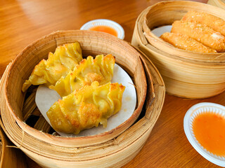 Fried Dumplings in a bamboo steamer bowl. Chinese food menu.