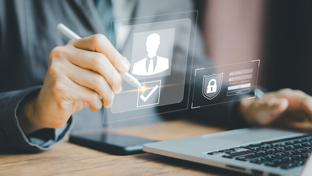 Businessman Digital Identity Verification, Hand holding stylus interacts with virtual security interface, Laptop background.