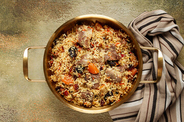 rice dish with meat and dried fruits, in a large pot, pilaf, homemade, no people