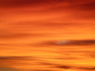 Fototapeta premium Dusk, Sunset Sky Clouds in the Evening with colorful Orange, Yellow, Pink and red sunlight and Dramatic storm clouds on Twilight sky, Landscape horizon