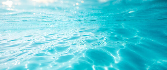 Crystal clear water surface reflecting sunlight in swimming pool