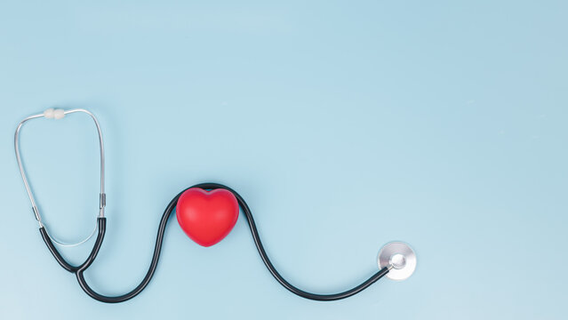 Stethoscope and red hearts on light blue background, Health care concept, Hospital life insurance concept, World heart health day, Doctor day, World hypertension day. - Powered by Adobe