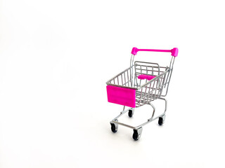 Miniature Shopping Cart With Pink Handles And Basket On White Background, Studio Setting, Ideal For Marketing Concepts, Online Shopping, E-Commerce, Retail Promotions, Business Advertising, Consumeris