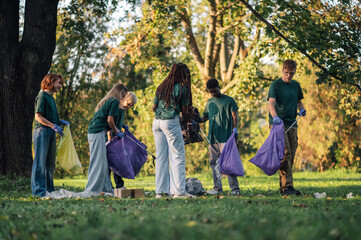Group of volunteers collecting garbage in park