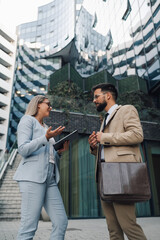 Business people having conversation about work outdoors