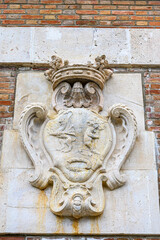 Ancient coast of arms symbol in brick wall, Madrid, Spain