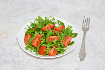 Simple Tomato and Arugula Salad with a fork