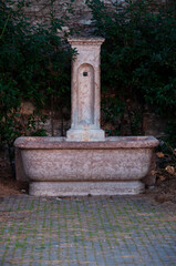 vintage fountain with drinking water in a public park in Italy