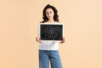 Back to school, international Pi day concept. Beautiful young woman holding school blackboard with pi sign on it written with white charcoal. Studio shot against beige background with copy space