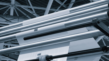Automatic polyethylene plastic bag production machine with lighting effect. Close-up of the roller...
