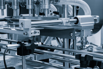 Fragment of the conveyor of sticking labeling machine. Abstract industrial background.