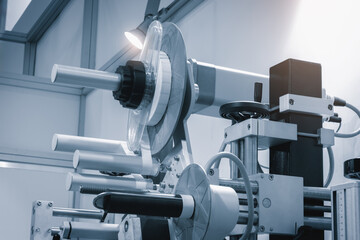 Fragment of the conveyor of sticking labeling machine. Abstract industrial background.