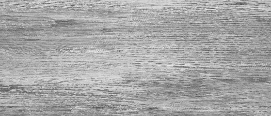 A wooden surface with a grainy texture. The wood is grey and has a rough appearance. The surface is not smooth and has a lot of texture