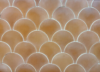 Texture of Japanese fish scales or Chinese fish skin wave and curve pattern. Asian curved fan and fish scales pattern, in beige brown color. Seamless background texture. © TMR Studio