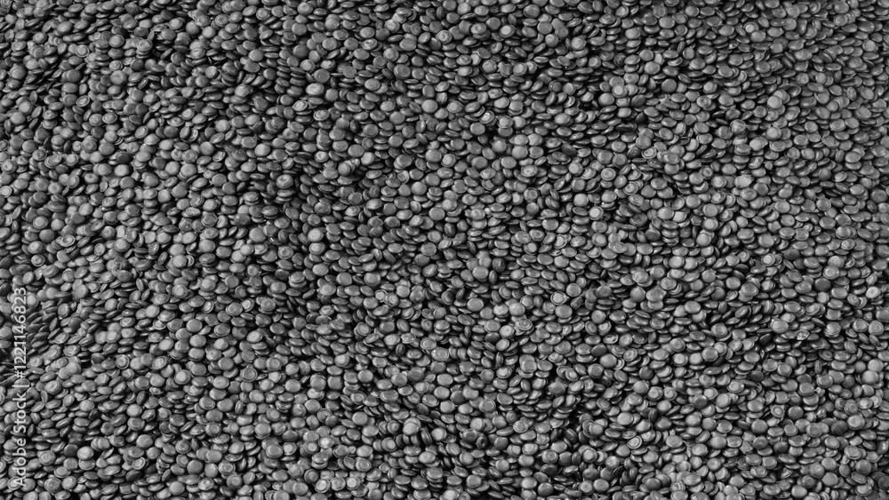 Poster black texture background of a pile of black beans. beans are scattered all over the surface, with so