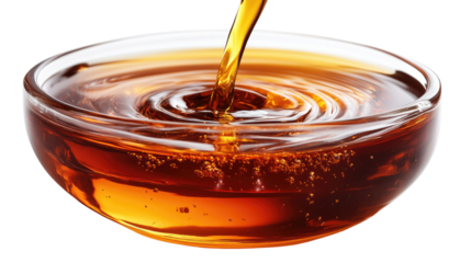 Amber Liquid Pouring: Rich, amber liquid pours into a clear glass bowl, creating mesmerizing swirls and ripples. The texture and color are intensely captivating. 