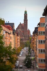 Obraz premium Engelbrekt church view over Stockholm street with colorful buildings, autumn trees and blurred foreground