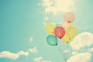 A vibrant bunch of colorful balloons is soaring gracefully in the sky