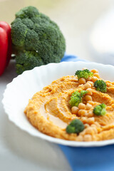 Creamy hummus topped with chickpeas and broccoli florets.  A healthy and delicious vegetarian meal.