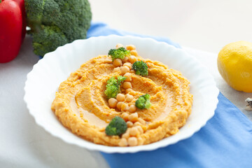 Creamy hummus with chickpeas and broccoli florets.  A healthy and delicious meal or appetizer.