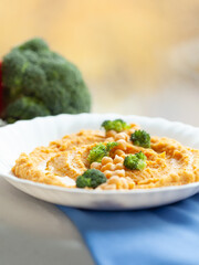 Delicious sweet potato hummus topped with chickpeas and broccoli florets. A healthy and flavorful vegetarian meal or snack.