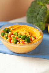Creamy orange puree topped with chickpeas, broccoli, and bell peppers.  A healthy and vibrant meal.
