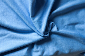 Close-up of textured blue fabric. Soft, draped material with subtle wrinkles and folds. Perfect for...