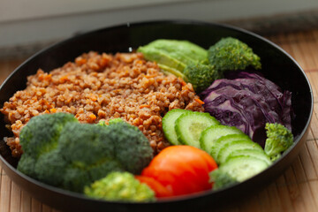 Healthy buckwheat bowl with assorted vegetables.  A nutritious and delicious meal.