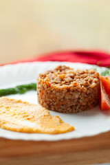 A delicious and healthy buckwheat dish, served with a side of creamy puree and fresh tomato slices. Perfect for a light meal or a healthy side dish.