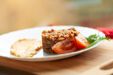Hearty buckwheat dish with tomato and creamy sauce. A simple, healthy, and delicious meal.