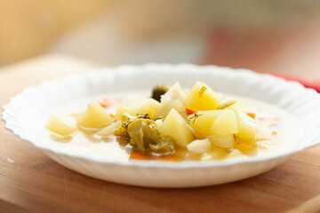 Hearty vegetable soup in a white bowl, perfect for a comforting meal.