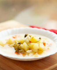 A bowl of hearty vegetable soup, perfect for a comforting meal.  Potatoes, carrots, and broccoli are visible in a light broth.