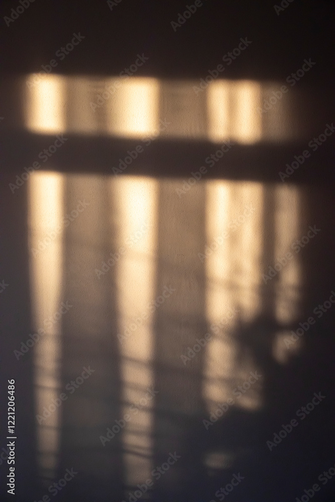 Aufkleber soft, warm light casting shadows on a wall, creating an abstract interplay of shapes and colors. per