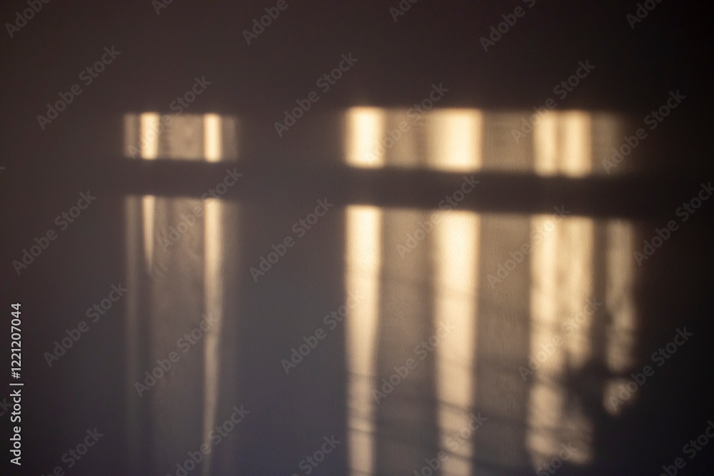 Poster soft light filtered through curtains creates an abstract play of shadows and warm tones, conveying a