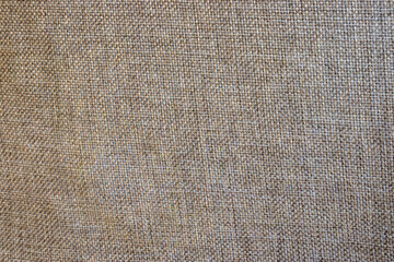 A close-up of a textured fabric, showcasing a warm beige tone. Ideal for backgrounds and design projects needing a natural and earthy touch.