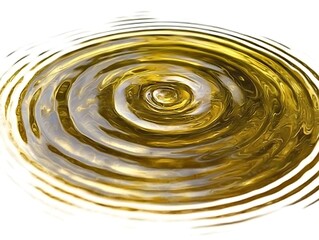 A stunning shot of perfect concentric ripples forming in calm water, with each ripple perfectly spaced, contrasting against a clean white background