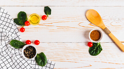 Cooking set spices, vegetables and herbs on white wooden background