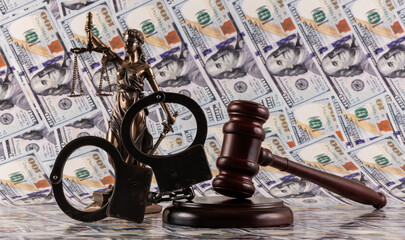 Handcuffs, judge's gavel and $100 bills