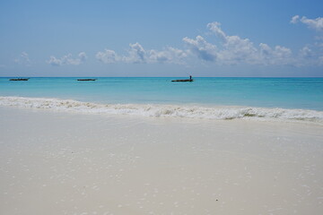 Jambiani beach and fishing boats on Indian Ocean in African Zanzibar island in Tanzania