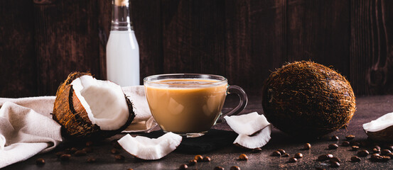 Vietnamese coconut coffee in a cup and coconut pieces on the table web banner