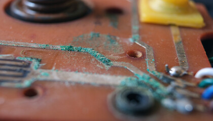 Oxidized copper lines which appears green in color on an electronic circuit board. Selected focus.