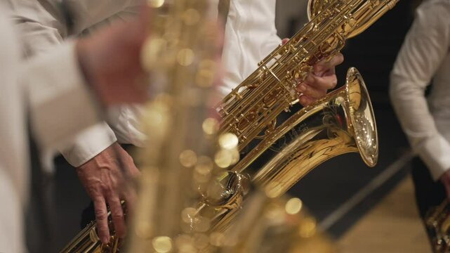 Saxophonist playing golden saxophone in Brass Quintet on teh stage, Close up.