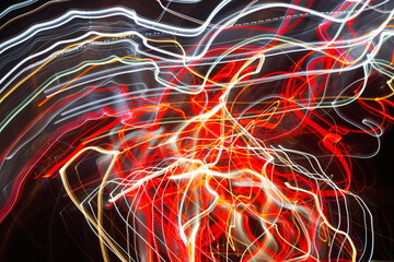 Abstract blurred colorful light effect on a black background. Long exposure photo of moving camera.