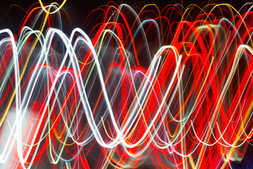 Abstract blurred colorful light effect on a black background. Long exposure photo of moving camera.