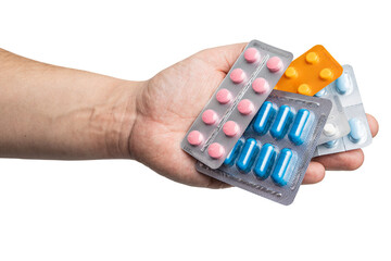 Male hand holding various blister packs with medicine capsules, antibiotic pills, or painkillers, isolated on transparent background. healthcare and treatment concept